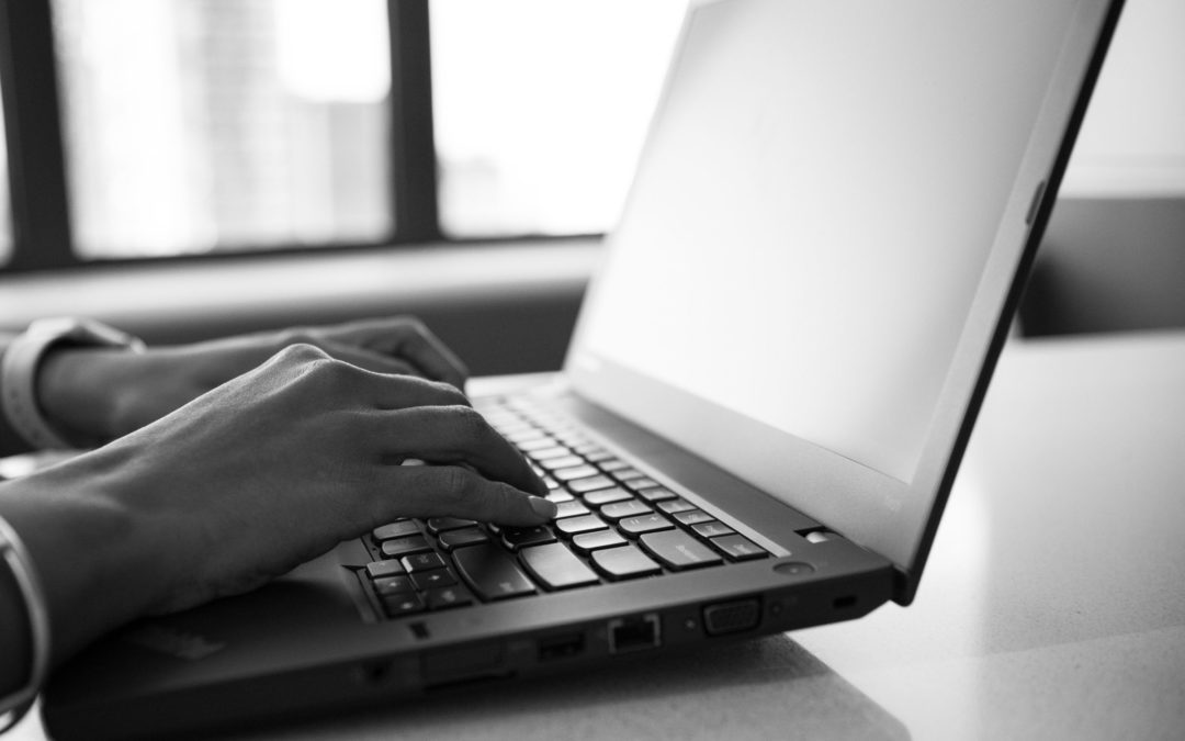 woman typing on a laptop - Thinking About an Online Mortgage Lender?